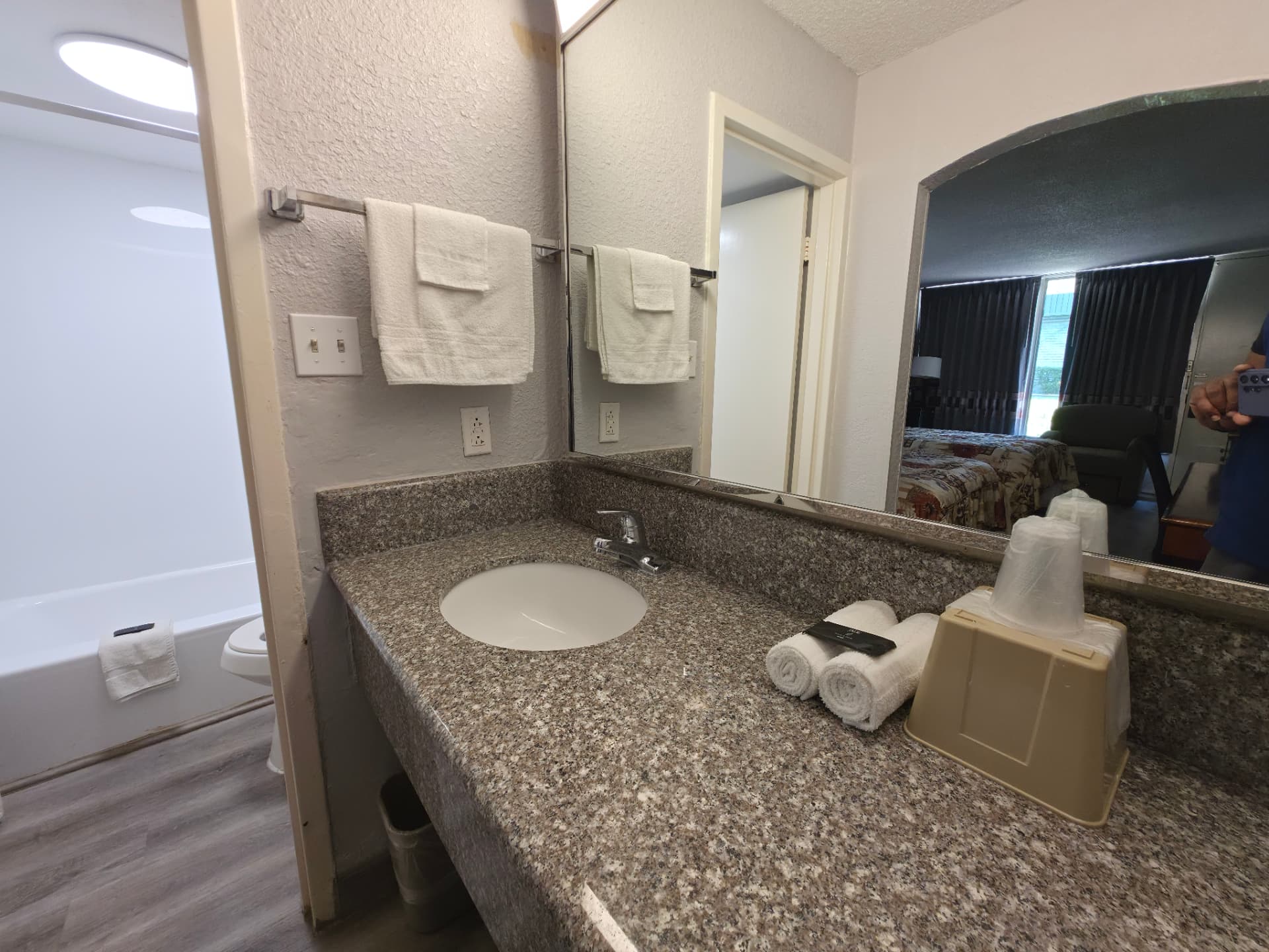 King room bathroom vanity with granite counter, large mirror and fresh towels